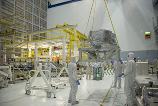 Engineers hoisted NASA's Webb telescope's Near Infrared Spectrograph or NIRSpec from its shipping container to a dolly in the clean room.