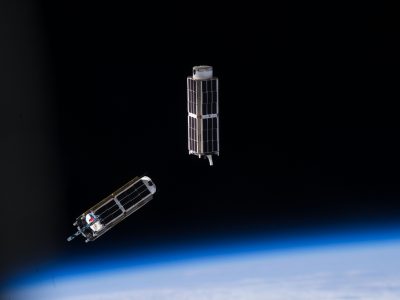 Three-unit (3U) CubeSats orbit above the Earth.