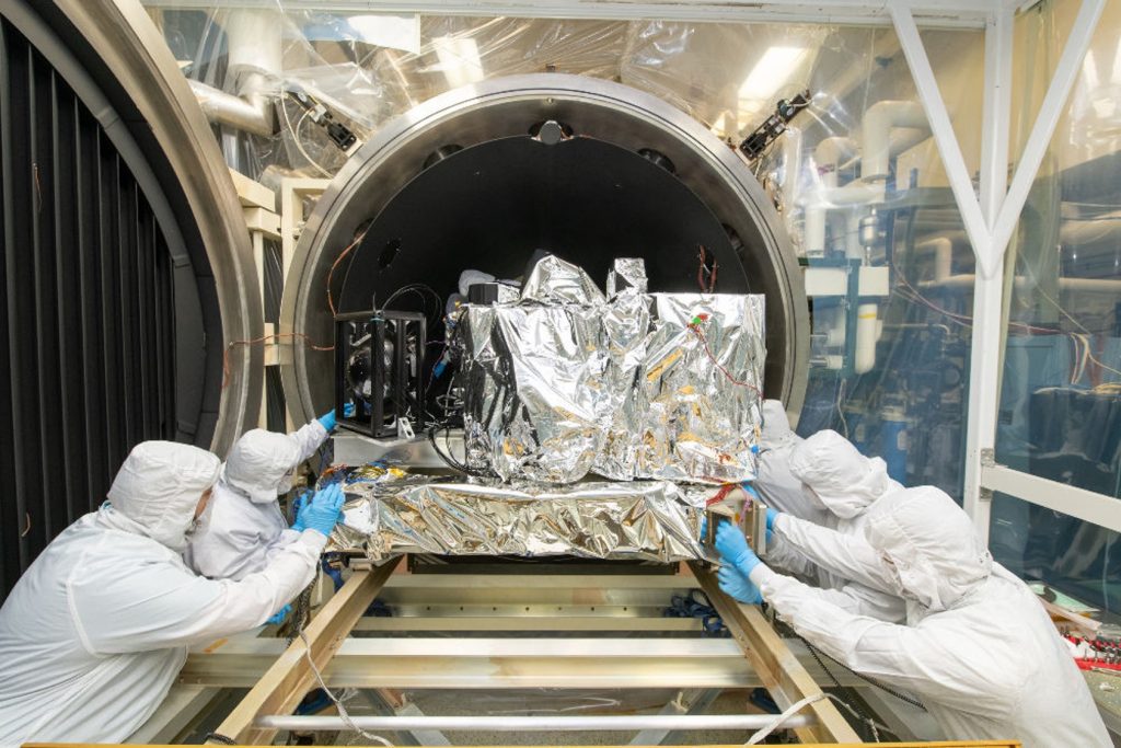 The Ocean Color Instrument (OCI) pushed by the team into the Thermal Vacuum Chamber (TVAC) for environmental testing.