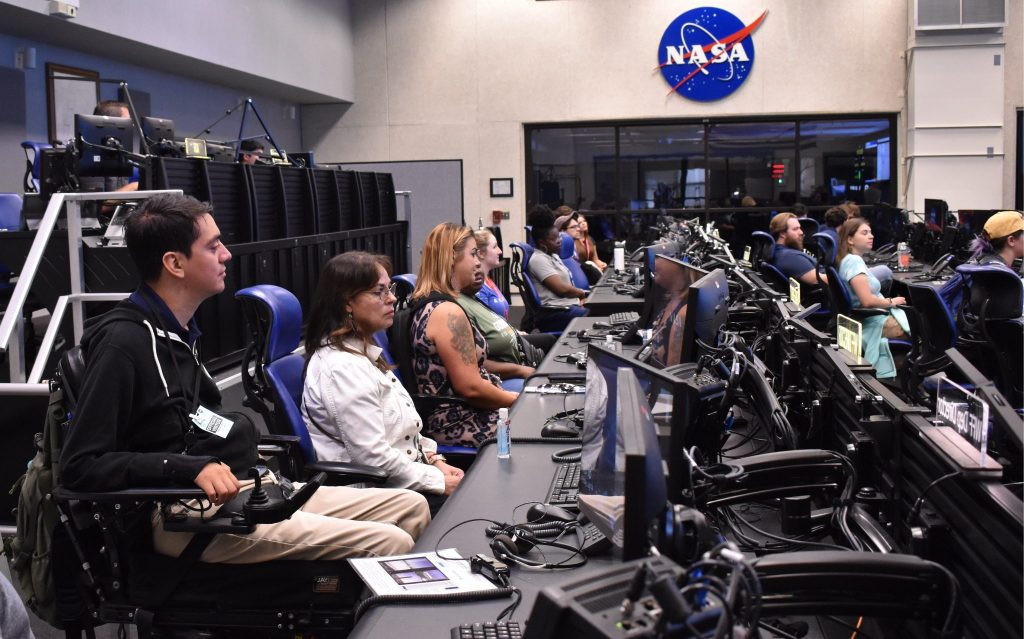 Interns sit on-console to listen to a briefing by the Wallops Director of Launch and Flight Operations.