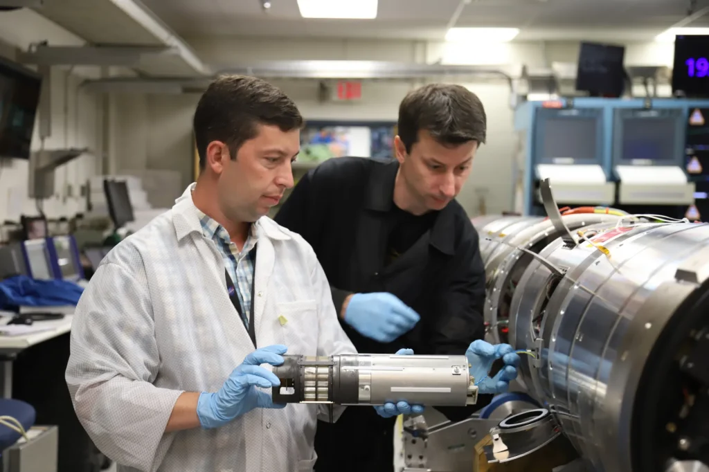 Engineers Josh Yacobucci (left) and Scott Hesh test fit a science sensor sub-payload into a Black Brant sounding rocket at Wallops.