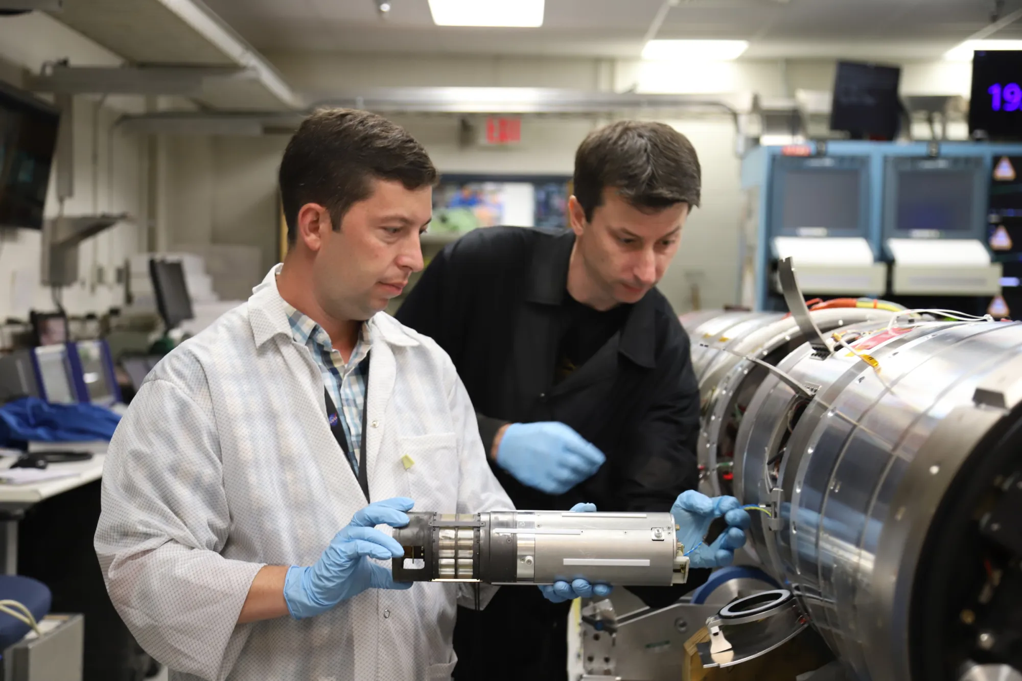 Engineers Josh Yacobucci (left) and Scott Hesh test fit a science sensor sub-payload into a Black Brant sounding rocket at Wallops.