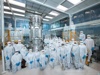 A team of NASA engineers dressed in cleanroom suits standing around a component of the Europa clipper.