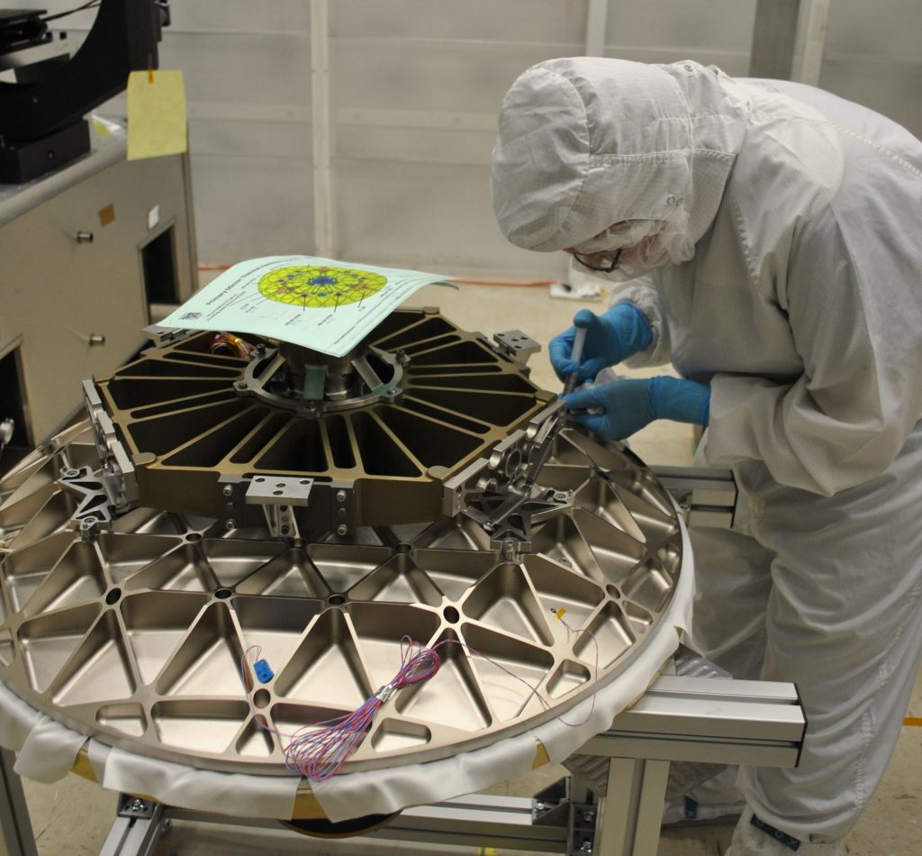 An engineer attaches components to ICESat-2's beryllium telescope, before it is attached to the satellite's ATLAS instrument.