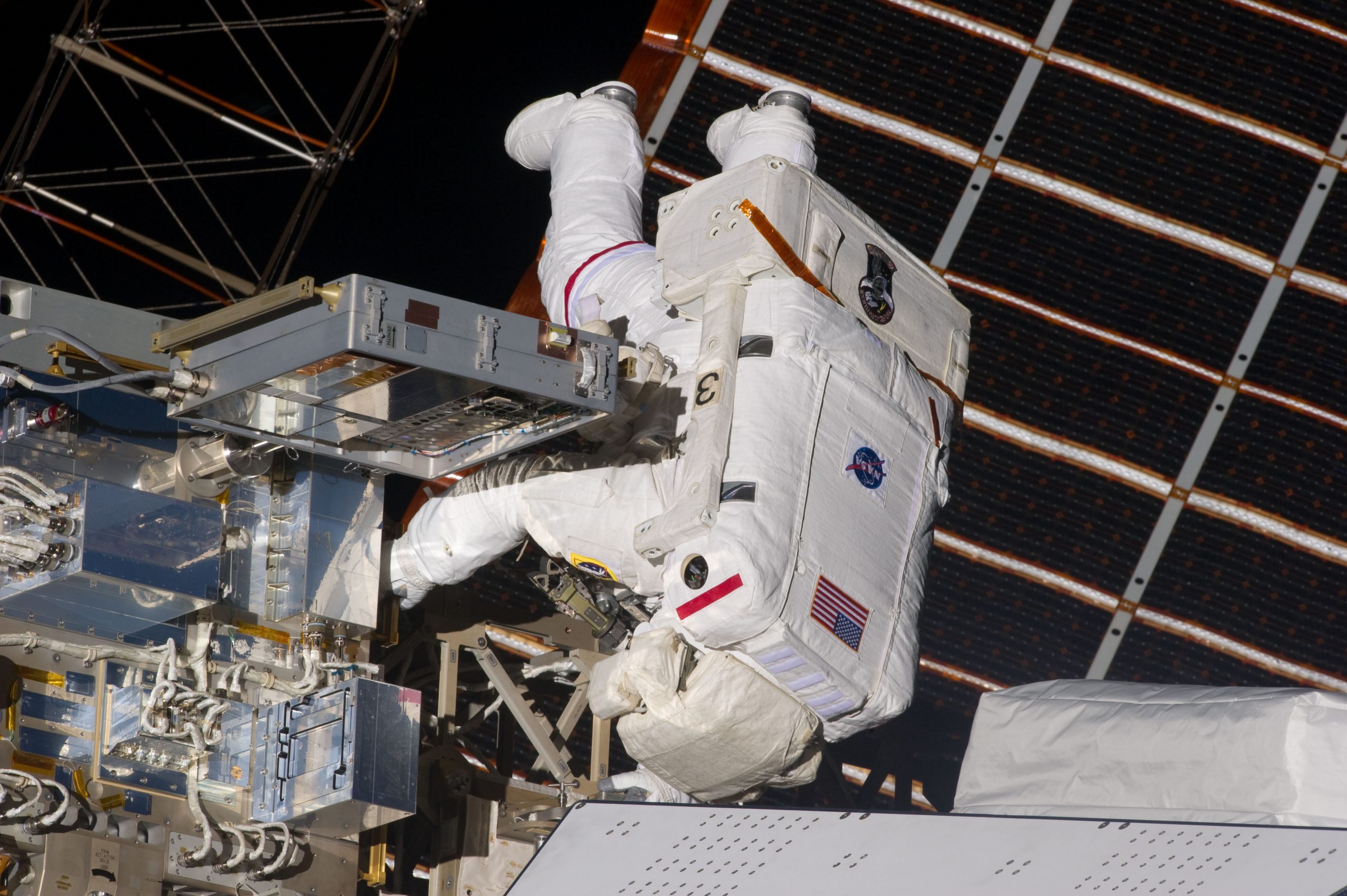 Astronaut installs the MISSE-7 pallet onboard the ISS, which contains a 587 spacecube as part of the payload. The Materials International Space Station Experiment was a joint program between the DoD and NASA to investigate the suitability of different materials and technologies in space.