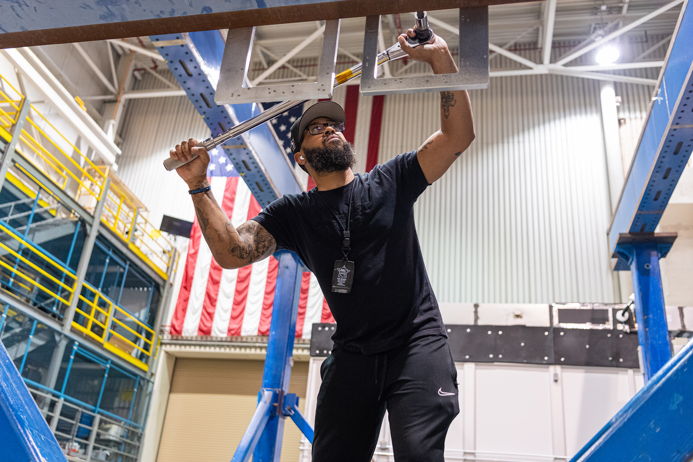 Mechanical engineering and integration technician Ivan Pratt installs brackets onto the static load testing platform in preparation of an OSAM-1 ground support equipment proof test at Goddard Space Flight Center, Greenbelt Md., July 19, 2023. NASA/Mike Guinto