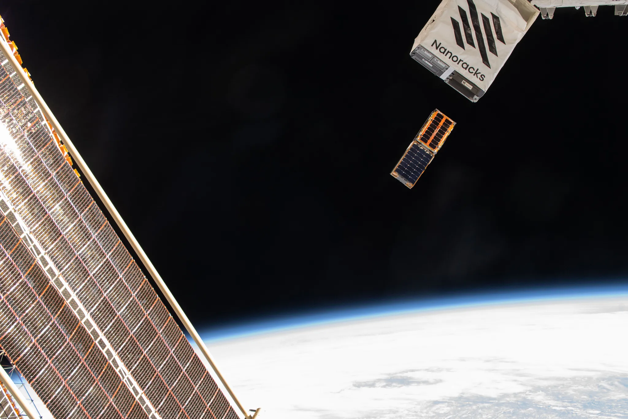 The BurstCube and SNOOPI satellites deploy into space in this photograph.