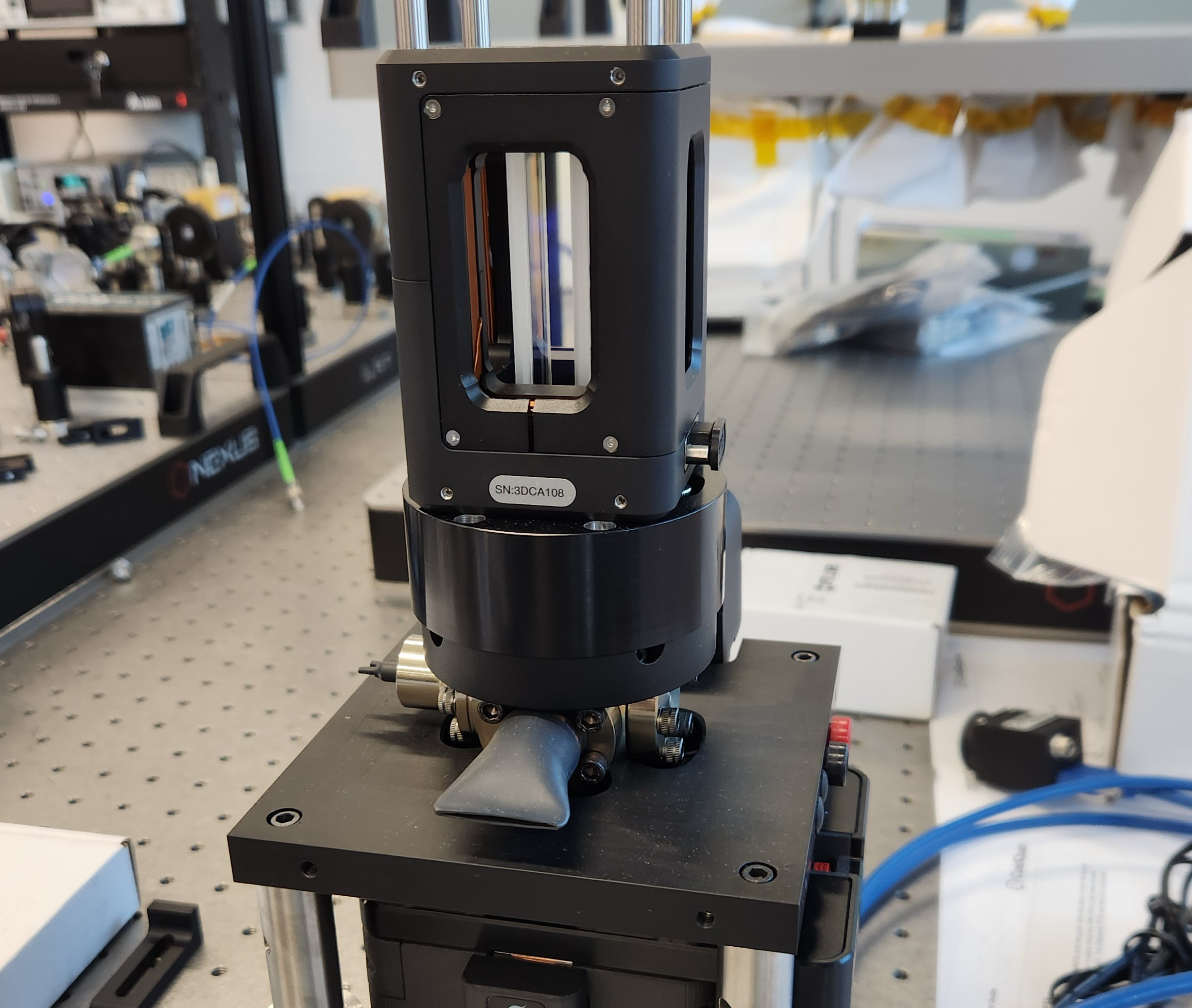 Photonically integrated Cs cold atom source and three-dimensional magneto optical trap cooling chamber