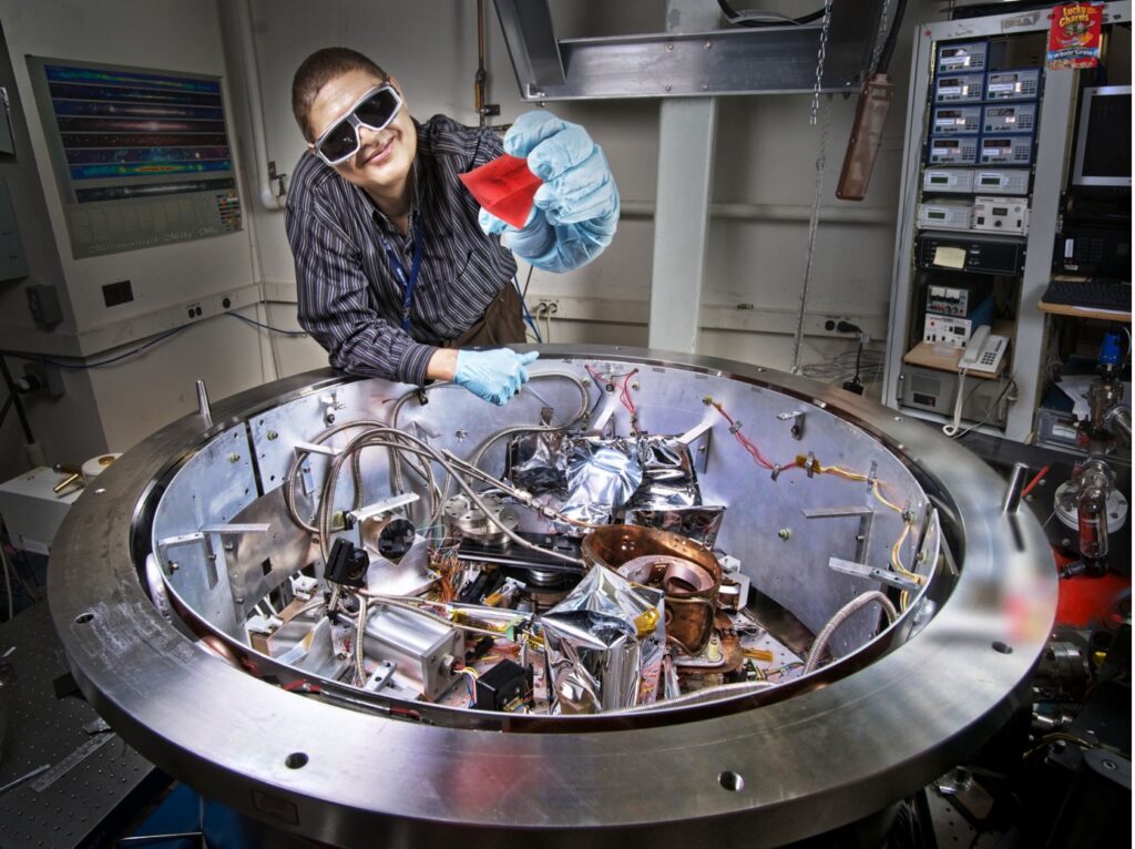 This image shows Dr. Manuel Quijada and Goddard’s Cryogenic, High-Accuracy Refraction Measuring System (CHARMS).