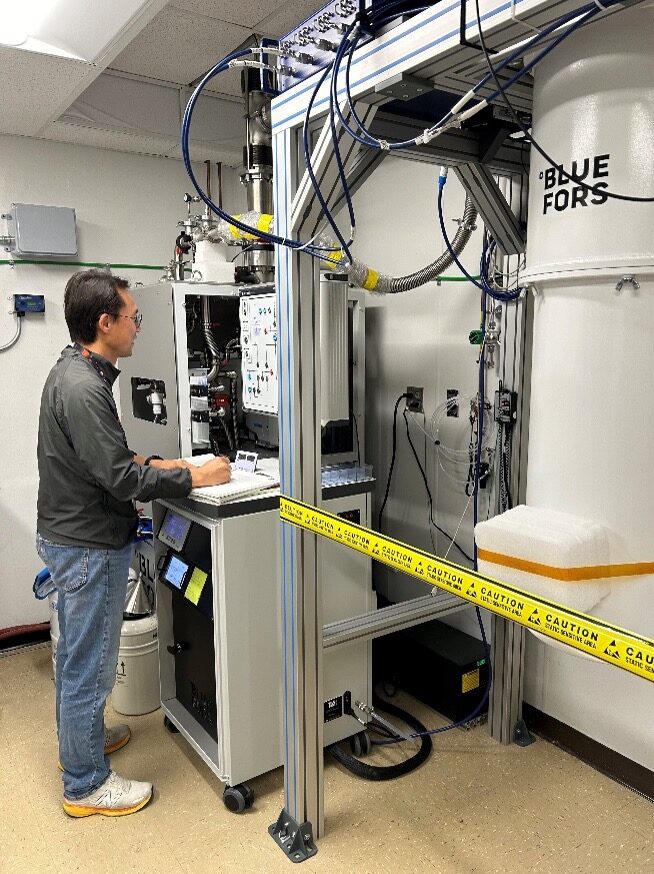 Wonsik Yoon operates a dilution refrigerator to test microwave amplifiers at sub-Kelvin temperatures at Goddard Space Flight Center lab.