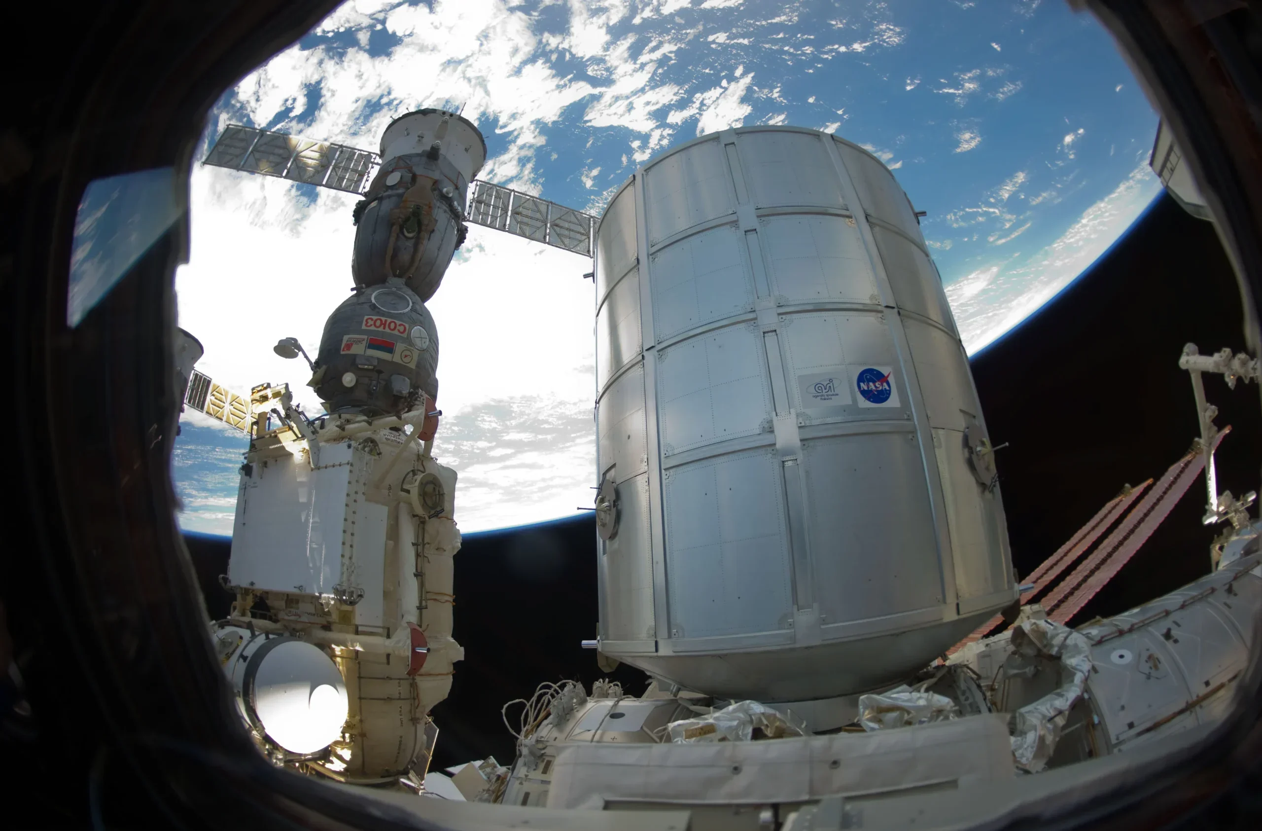 The newly-attached Permanent Multipurpose Module (PMM) and a docked Russian Soyuz spacecraft are featured in this image photographed by an Expedition 26 crew member. 