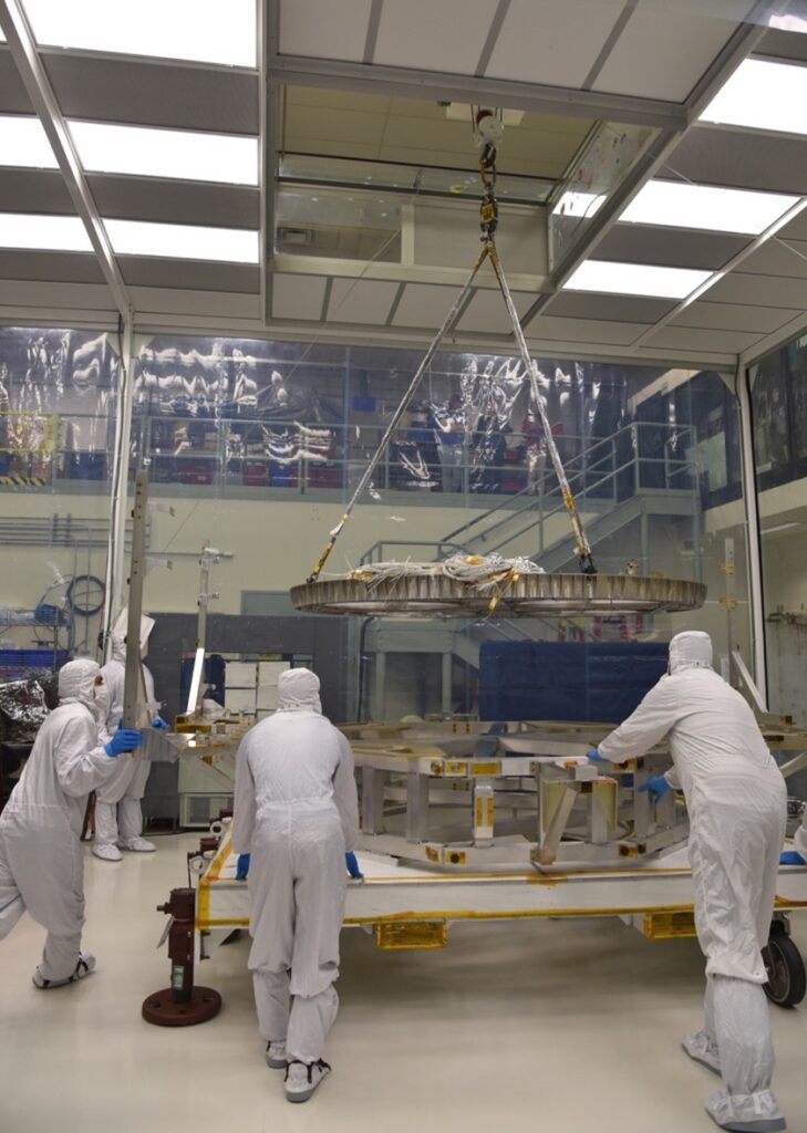 Engineers and technicians execute a crane lift of the Propulsion Deck for the Roman Space Telescope propulsion system.