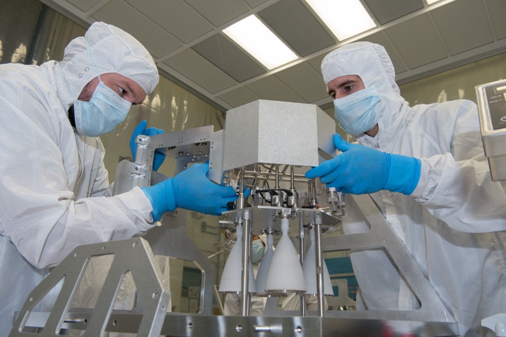 Propulsion technician and engineer assemble a Rocket Engine Module (REM) for the Europa Clipper mission.